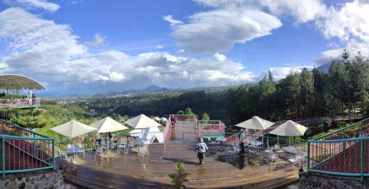 Area glamping dan wahana di Wisata Alam Sevillage dengan latar belakang pegunungan Puncak.